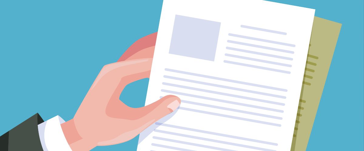 a hand is holding several documents