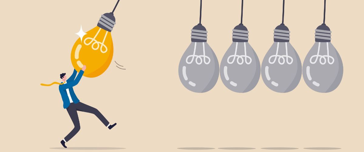 Eine Illustration eines Mannes, der an einer leuchtenden Glühbirne hängt.